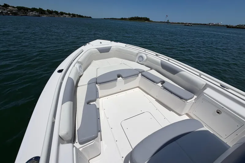 Slide: The Image of 2017 Everglades 243 Center Console boat with spacious seating on calm waters. - 25