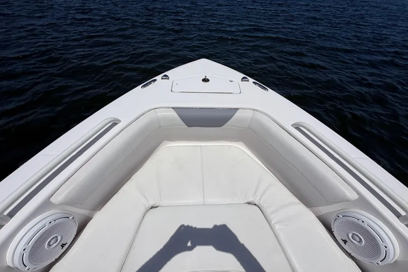 Slide: The Image of Bow seating area of 2017 Everglades 243 Center Console boat on water. - 27