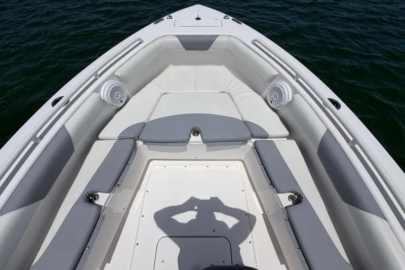 Slide: The Image of Bow seating area of 2017 Everglades 243 Center Console boat on water. - 28