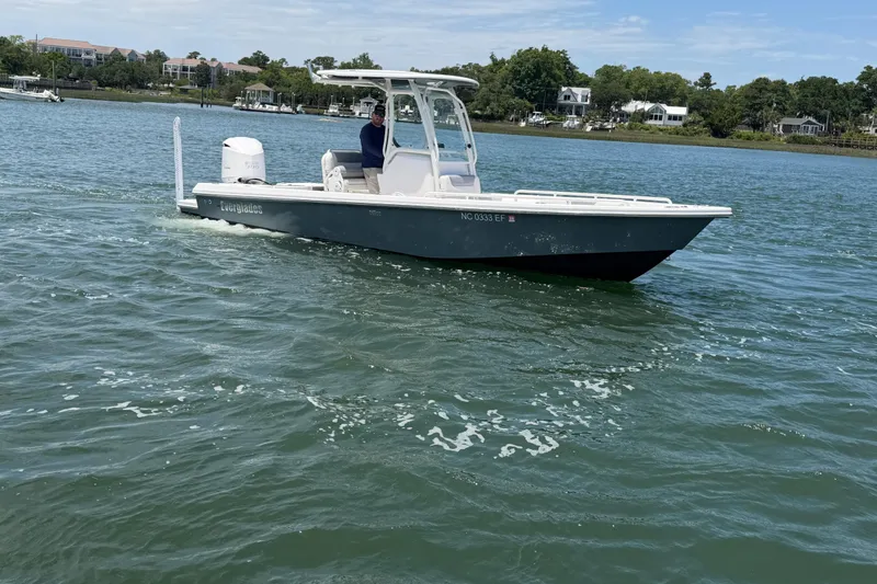 Slide: The Image of 2017 Everglades 243 Center Console boat cruising on a calm lake. - 3