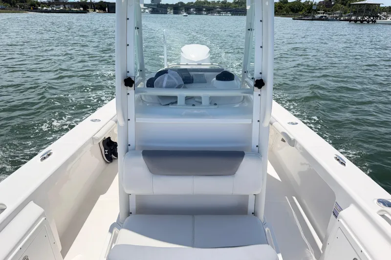 Slide: The Image of 2017 Everglades 243 Center Console boat on calm water, showcasing seating and console. - 30