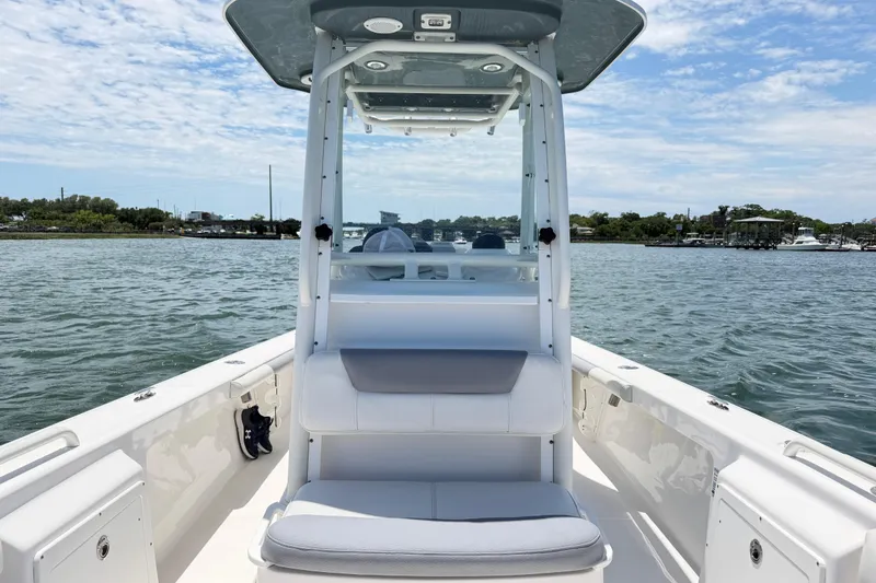 Slide: The Image of 2017 Everglades 243 Center Console boat on calm water, showcasing seating and console. - 31