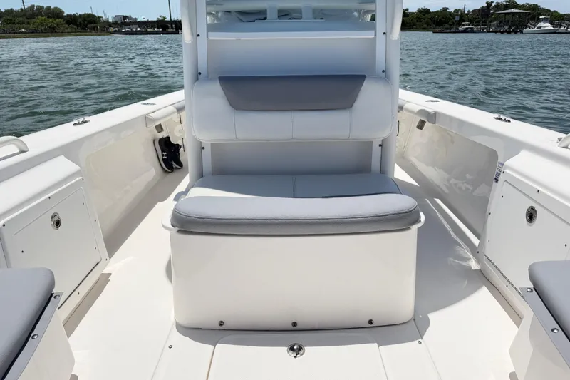 Slide: The Image of 2017 Everglades 243 Center Console boat interior with seating, on calm water. - 32