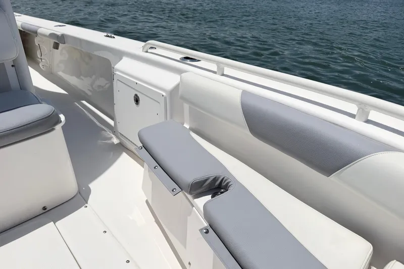 Slide: The Image of 2017 Everglades 243 Center Console boat interior with cushioned seating by the water. - 33