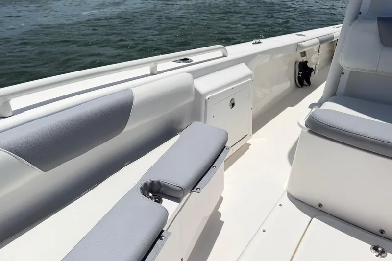 Slide: The Image of 2017 Everglades 243 Center Console boat interior with seating and storage, on calm water. - 34