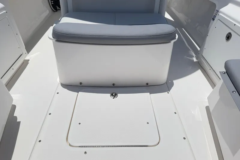 Slide: The Image of 2017 Everglades 243 Center Console boat interior with cushioned seating and storage compartment. - 35