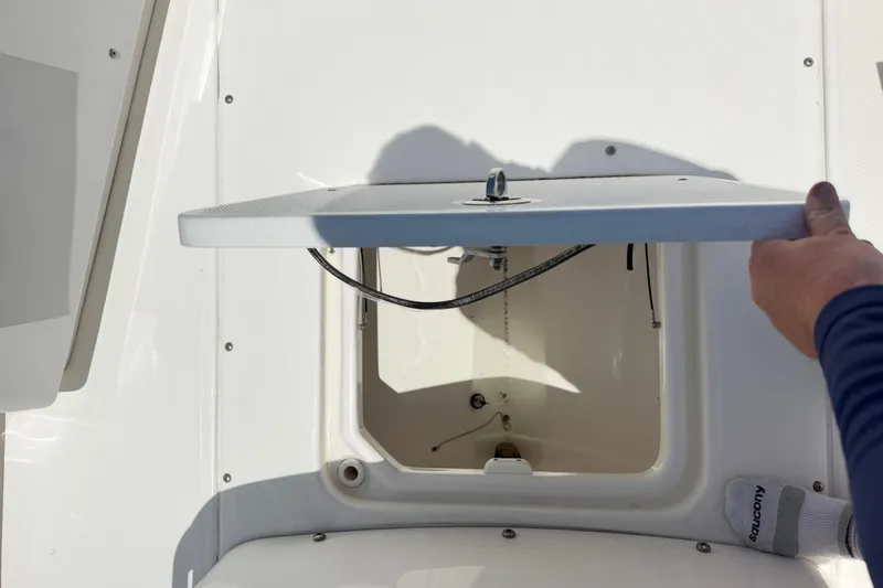 Slide: The Image of Open hatch on 2017 Everglades 243 Center Console boat, showcasing storage compartment. - 36