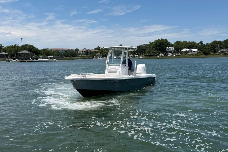 Slide: The Image of 2017 Everglades 243 Center Console boat cruising on a scenic waterway. - 4