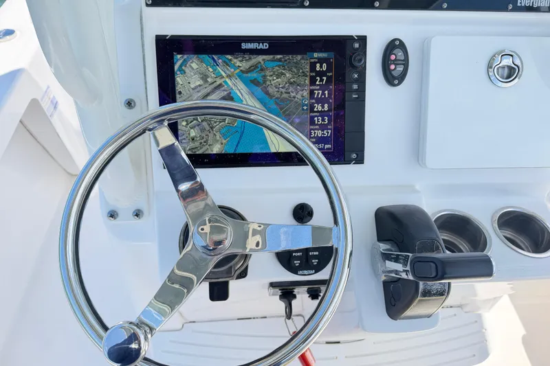 Slide: The Image of Steering console of a 2017 Everglades 243 Center Console boat with navigation display. - 49