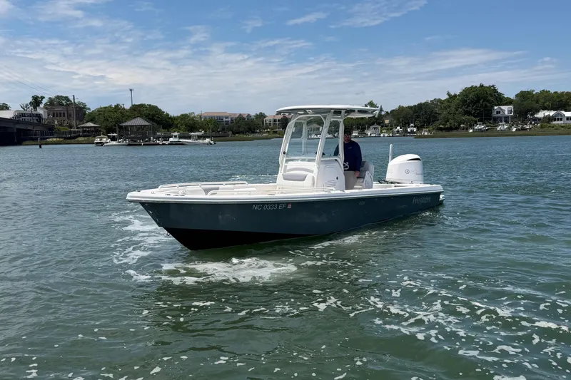 Slide: The Image of 2017 Everglades 243 Center Console boat cruising on a scenic waterway. - 5