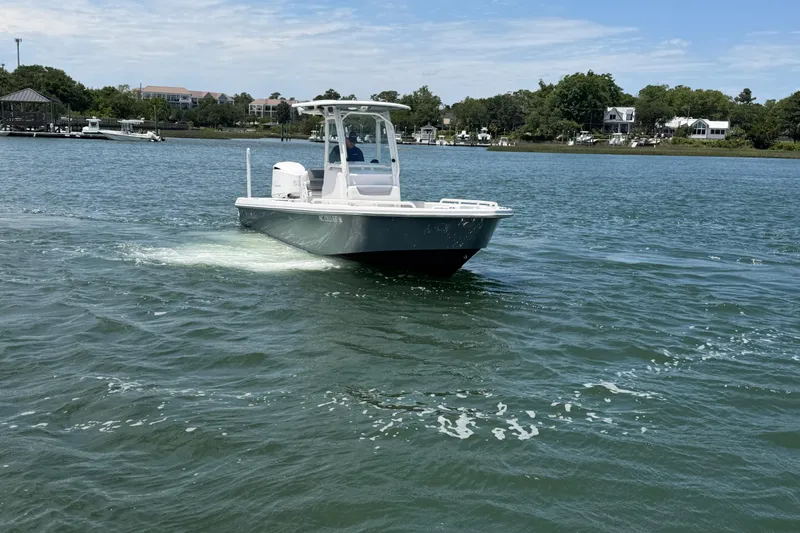 Slide: The Image of 2017 Everglades 243 Center Console boat cruising on a scenic waterway. - 9