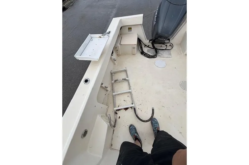 Slide: The Image of 2003 Parker 2120 Sport Cabin boat deck with ladder and motor. - 15
