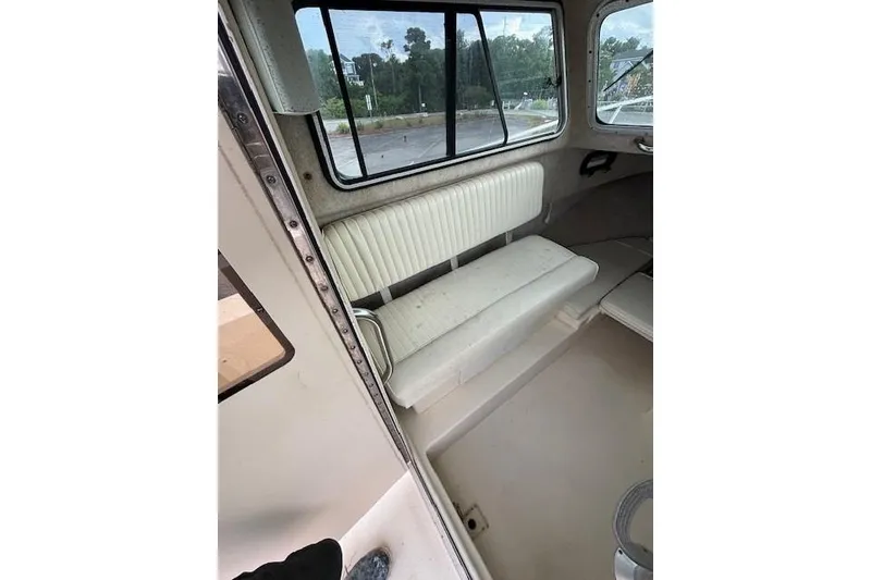 Slide: The Image of Interior of a 2003 Parker 2120 Sport Cabin boat with white seating. - 20