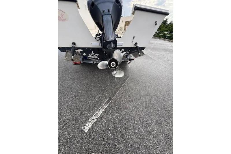 Slide: The Image of Rear view of a 2003 Parker 2120 Sport Cabin boat with visible propeller. - 8