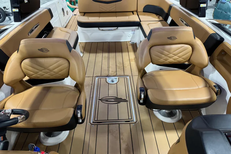 Slide: The Image of Luxurious interior of 2023 Chaparral 307 SSX boat with tan leather seating and wood flooring. - 11