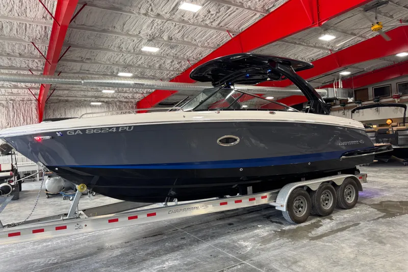Slide: The Image of 2023 Chaparral 307 SSX boat on trailer in indoor storage facility. - 2