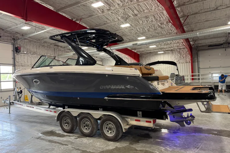 Slide: The Image of 2023 Chaparral 307 SSX boat on trailer in indoor showroom. - 3