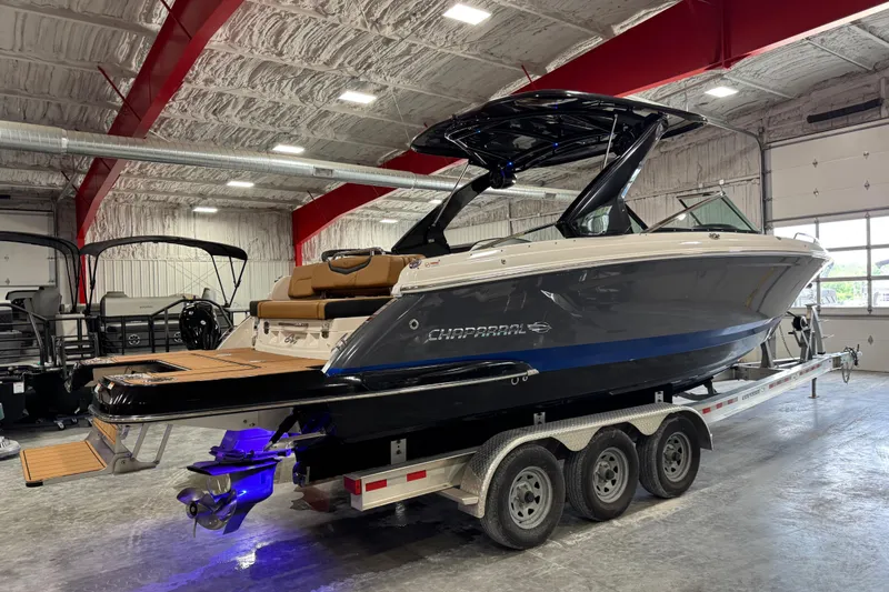 Slide: The Image of 2023 Chaparral 307 SSX boat on trailer in indoor showroom. - 4