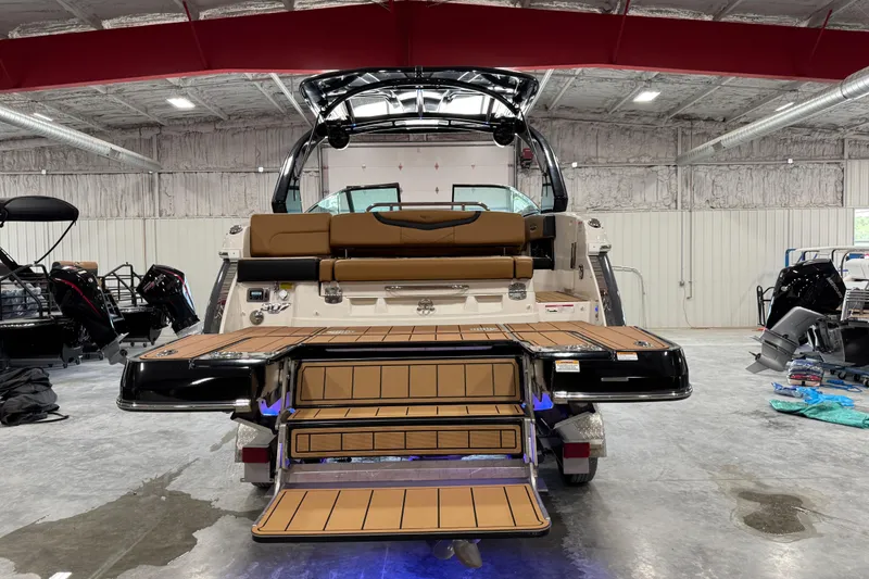 Slide: The Image of 2023 Chaparral 307 SSX boat in showroom, featuring sleek design and spacious deck. - 5