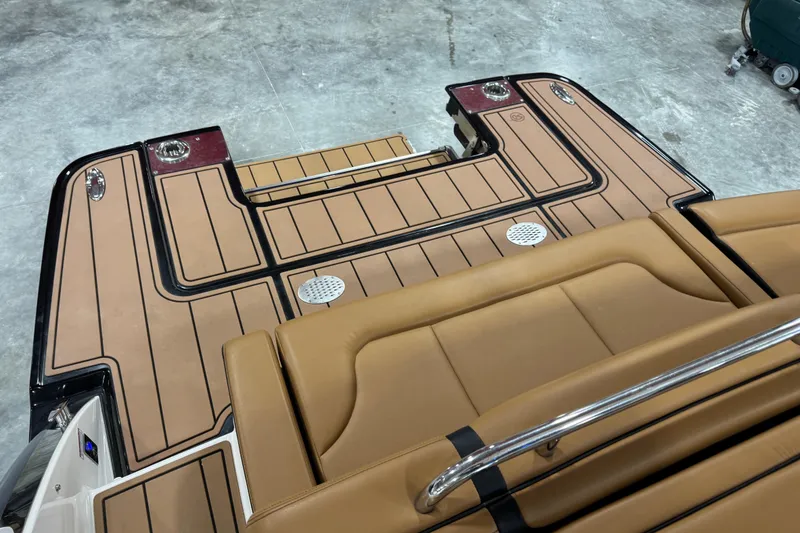 Slide: The Image of 2023 Chaparral 307 SSX boat deck with tan upholstery and sleek design. - 7