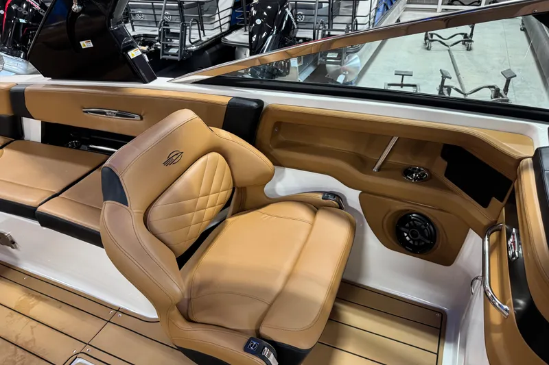 Slide: The Image of 2023 Chaparral 307 SSX boat interior with tan leather seating and modern design. - 9