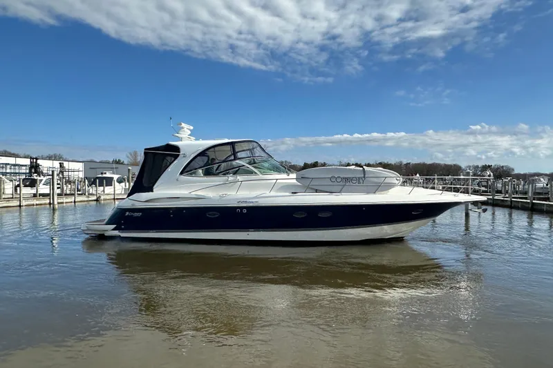 Slide: The Image of 2005 Cruisers Yachts 440 Express in marina, under clear blue sky. - 11