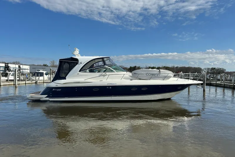 Slide: The Image of 2005 Cruisers Yachts 440 Express in marina, under clear blue sky. - 12