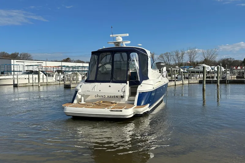 Slide: The Image of 2005 Cruisers Yachts 440 Express docked at marina under clear blue sky. - 14