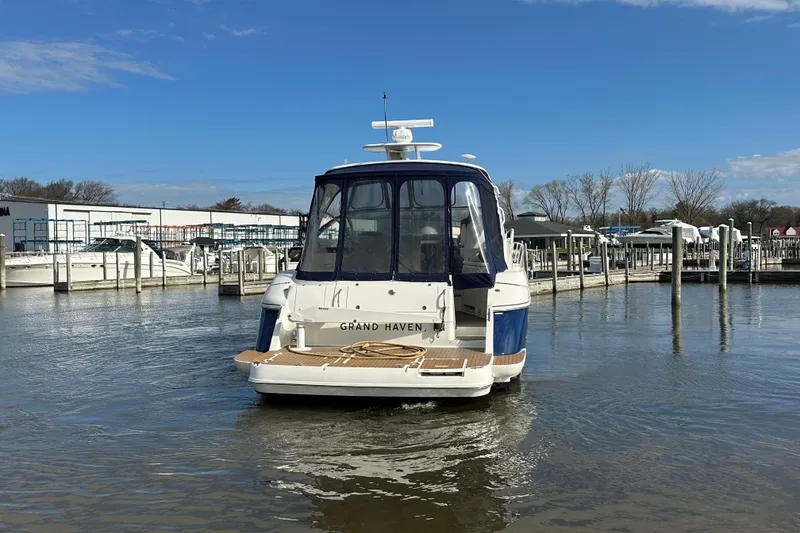 Slide: The Image of 2005 Cruisers Yachts 440 Express docked at marina under clear blue sky. - 15