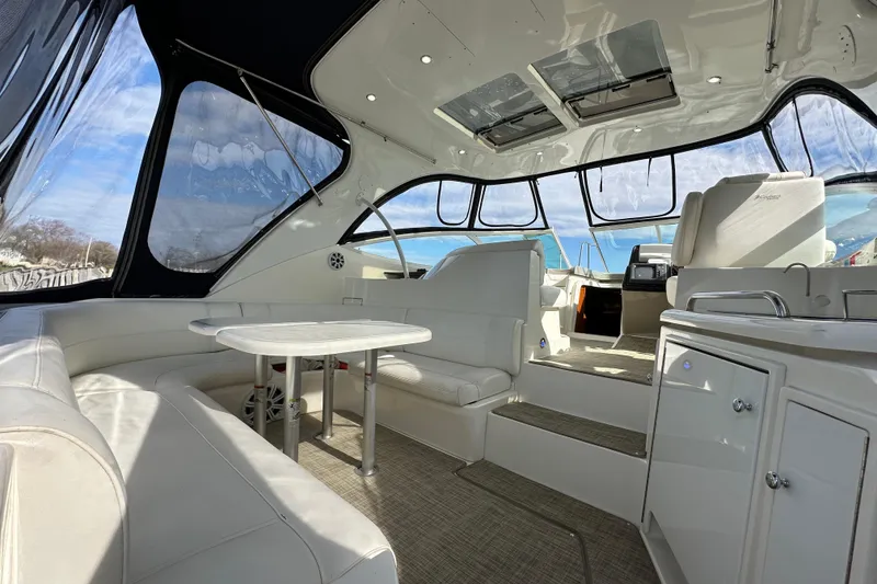 Slide: The Image of Luxurious interior of 2005 Cruisers Yachts 440 Express with plush seating and panoramic windows. - 16