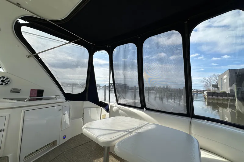 Slide: The Image of Interior view of 2005 Cruisers Yachts 440 Express with waterfront scenery. - 17