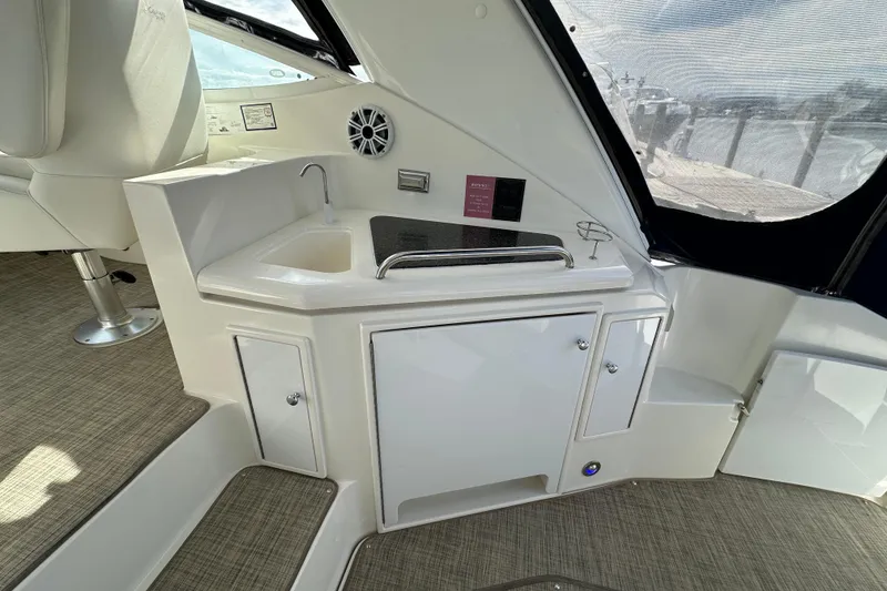 Slide: The Image of 2005 Cruisers Yachts 440 Express interior with sink and storage cabinets. - 18