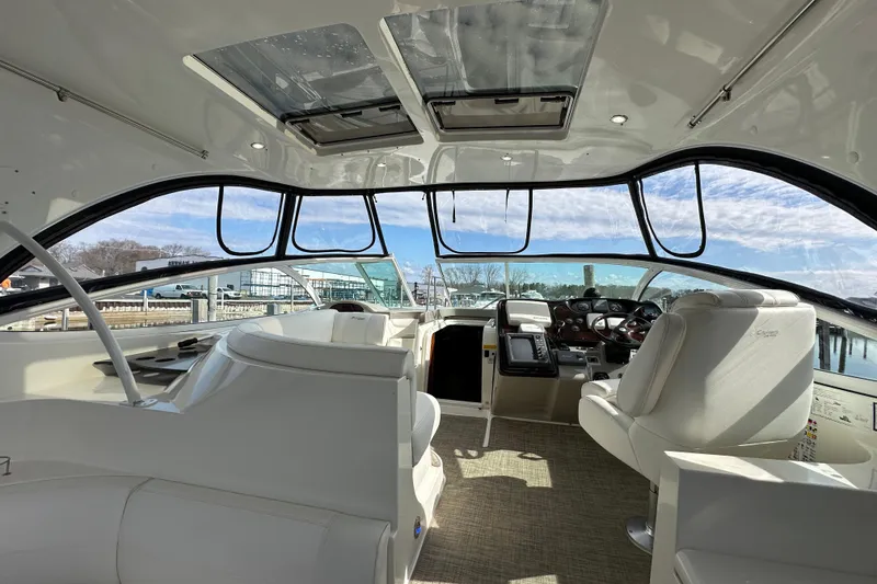 Slide: The Image of Interior view of 2005 Cruisers Yachts 440 Express, featuring helm and seating area. - 20