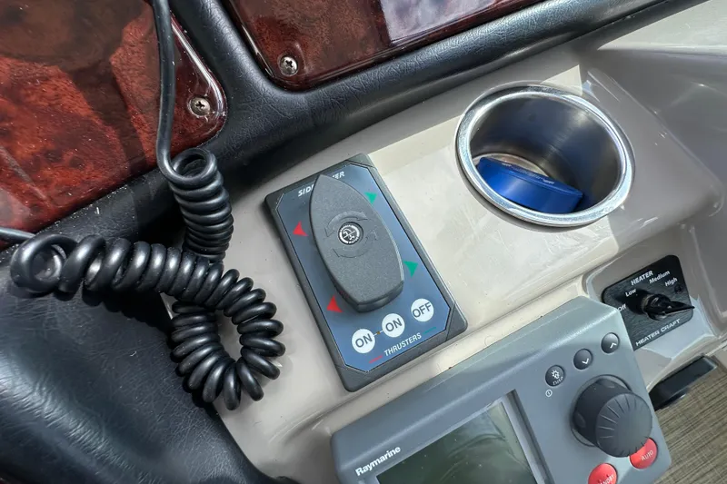 Slide: The Image of Control panel of a 2005 Cruisers Yachts 440 Express with thruster and heater controls. - 23