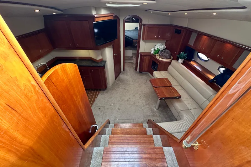 Slide: The Image of Luxurious interior of 2005 Cruisers Yachts 440 Express with elegant wood finishes and cozy seating. - 25