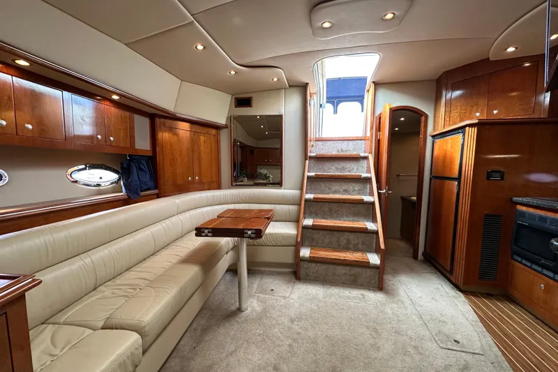 Slide: The Image of Luxurious interior of 2005 Cruisers Yachts 440 Express with elegant wood finishes and plush seating. - 27