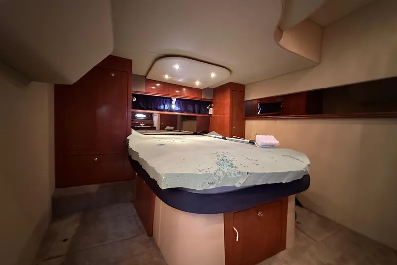 Slide: The Image of Interior cabin of 2005 Cruisers Yachts 440 Express with bed and wooden cabinetry. - 31