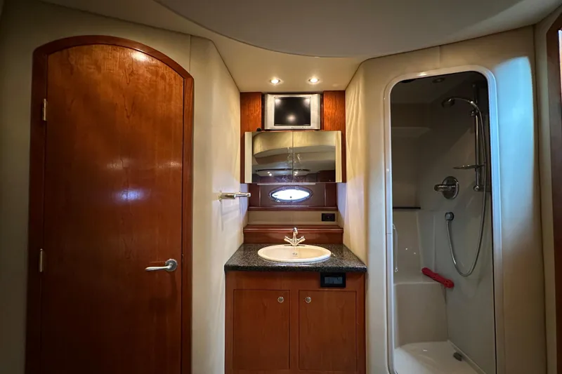 Slide: The Image of Luxurious bathroom in 2005 Cruisers Yachts 440 Express with wood accents and modern fixtures. - 32