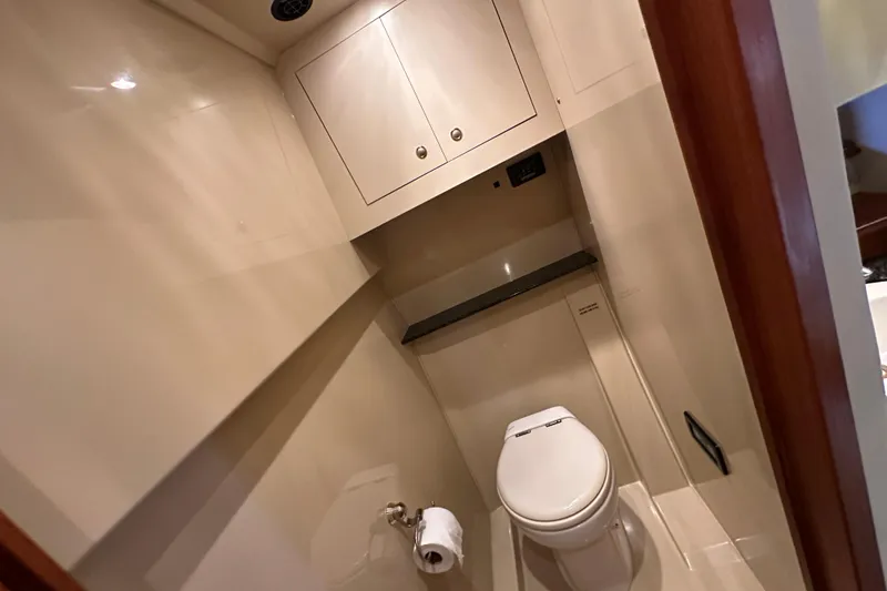Slide: The Image of Bathroom interior of 2005 Cruisers Yachts 440 Express, featuring modern fixtures and cabinetry. - 33