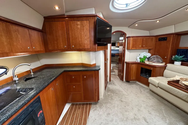 Slide: The Image of Luxurious interior of 2005 Cruisers Yachts 440 Express with elegant wood cabinetry. - 34