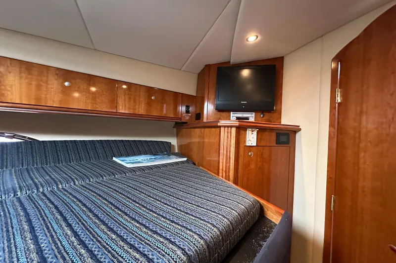 Slide: The Image of Luxurious cabin interior of 2005 Cruisers Yachts 440 Express with wood finish and TV. - 36
