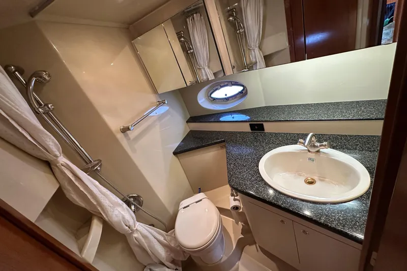 Slide: The Image of Luxurious bathroom in 2005 Cruisers Yachts 440 Express with granite countertop and shower. - 37