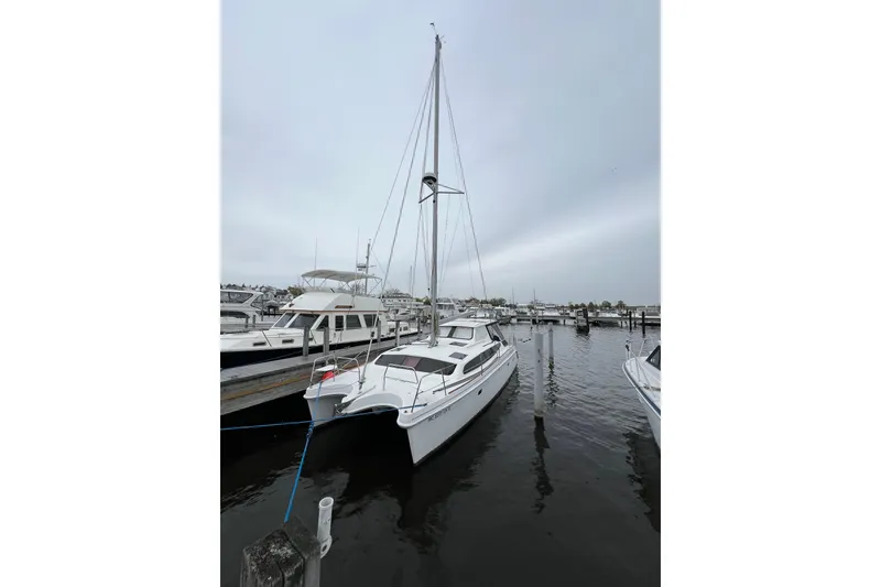 The Image of 2014 Gemini Legacy 35 catamaran docked at a marina under overcast skies. - 1