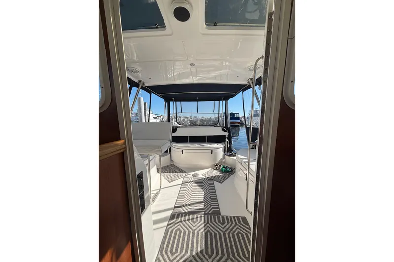 Slide: The Image of Interior view of 2014 Gemini Legacy 35 boat with seating and patterned rug. - 14