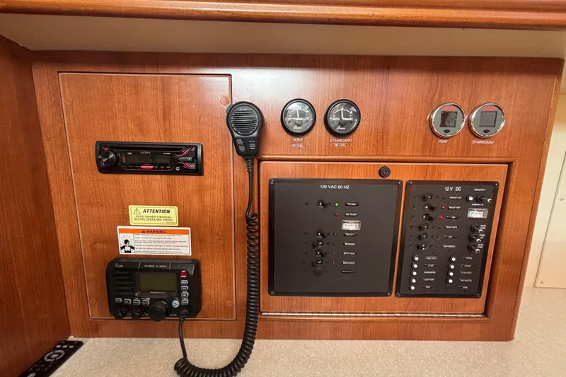 Slide: The Image of Control panel of a 2014 Gemini Legacy 35 boat with gauges and communication devices. - 16