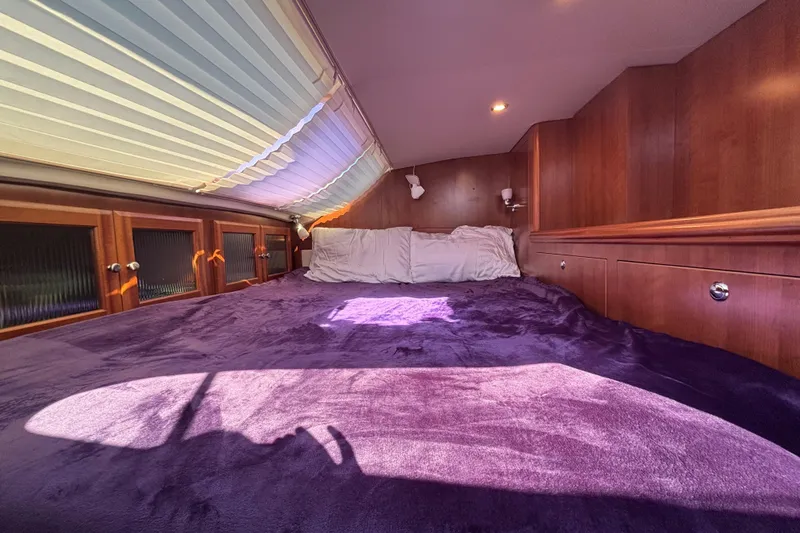 Slide: The Image of Cozy cabin interior of 2014 Gemini Legacy 35 with plush bedding and wooden accents. - 17