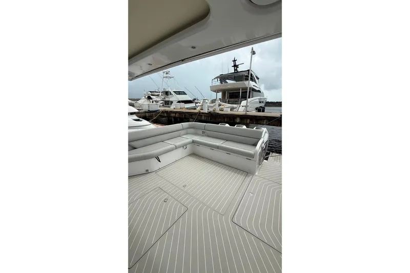 Slide: The Image of 2024 Azimut Verve 48 yacht deck with luxurious seating at marina. - 18