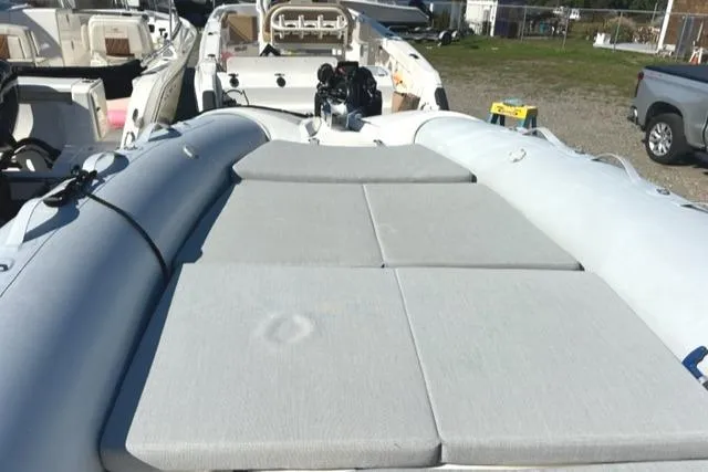 Slide: The Image of 2023 Zodiac N-ZO 680 boat with cushioned deck, parked outdoors. - 8