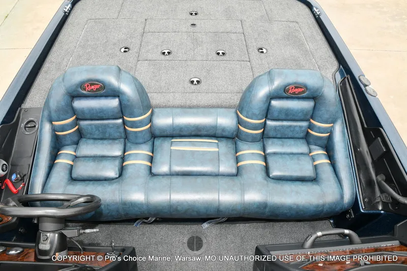 Slide: The Image of Interior of a 2002 Ranger 522vx boat with blue leather seats. - 11