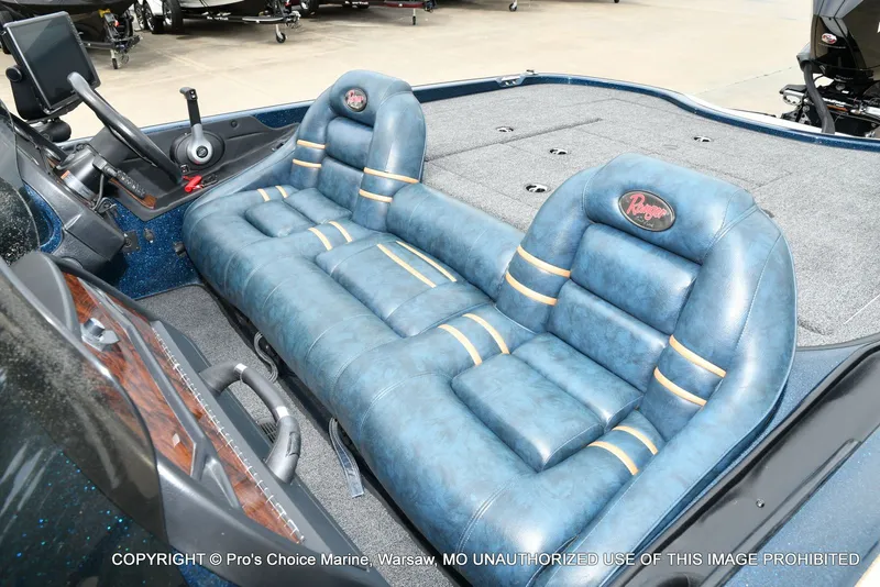 Slide: The Image of Interior of a 2002 Ranger 522vx boat with blue leather seats. - 17